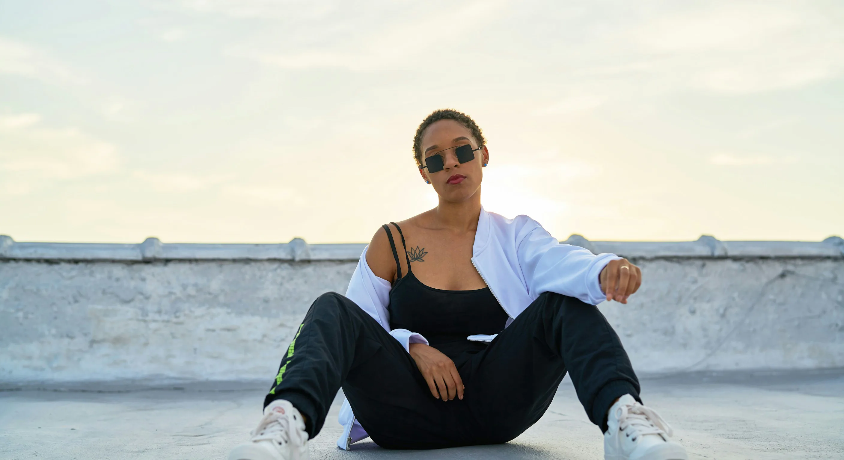 Model seated on a rooftop at golden hour