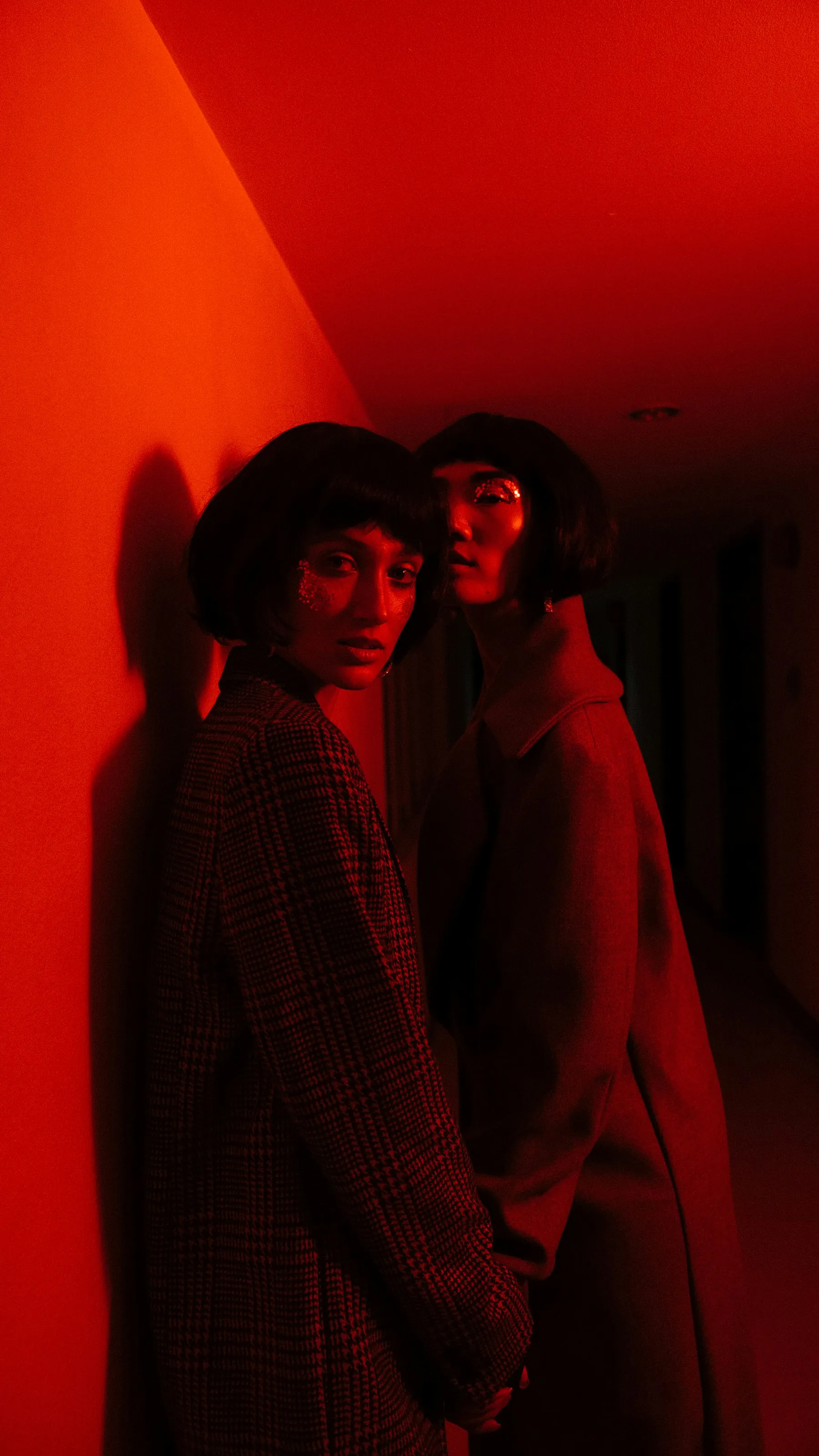 Two figures lit in red