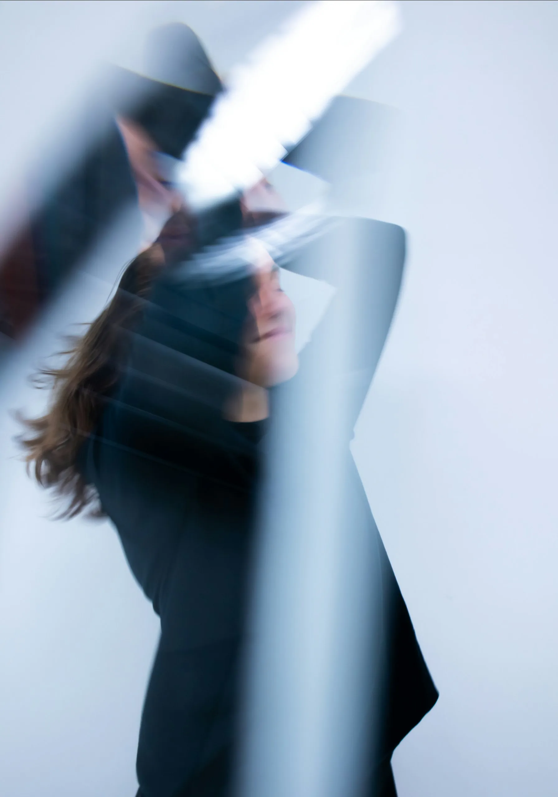Figure in motion against a pale backdrop